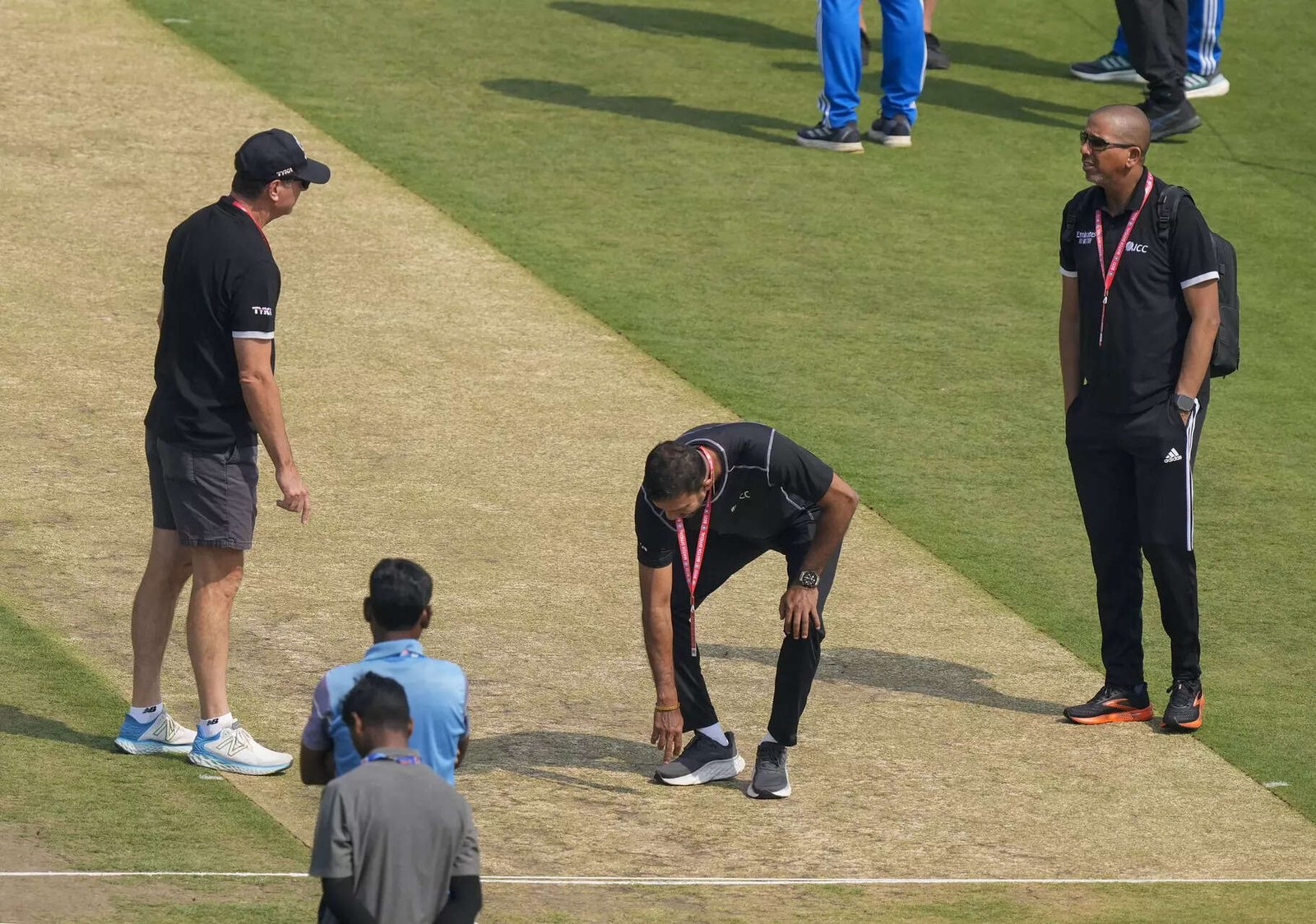 Ranchi: Officials inspect the pitch ahead of the fourth Test cricket match betwe...