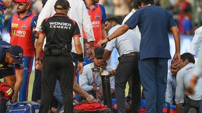 Delhi Capitals’ Lungi Ngidi receives treatment at the ground following a fall during the IPL match against PBKS. (Ajay Aggarwal/HT)