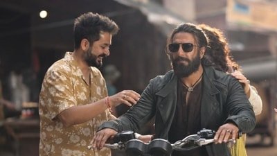 Aditya Dhar on the set of Dhurandhar with Ranveer Singh and Sara Arjun (hidden).