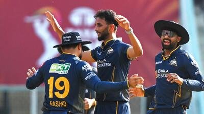 Gujarat Titans' Prasidh Krishna and Jos Buttler celebrate the wicket of Lucknow Super Giants' Mukul Choudhary. (ANI)