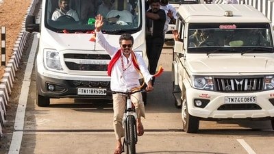 Tamilaga Vettri Kazhagam (TVK) chief and actor Vijay rides a bicycle during a roadshow ahead of the Tamil Nadu Assembly elections, in Kanniyakumari. (PTI)