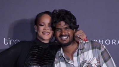Rihanna poses with paparazzi at an event in India.
