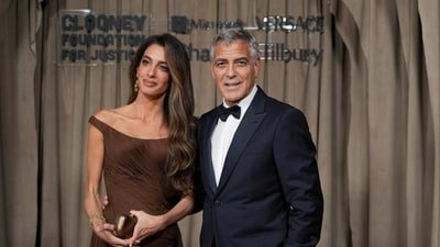 George Clooney celebrated his 65th birthday as Amal Clooney turned heads in a bold outfit. (REUTERS)