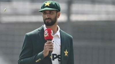 Pakistan captain Shan Masood (R) looks on during the toss before the start of the first day of the first Test cricket match against Bangladesh (AFP)
