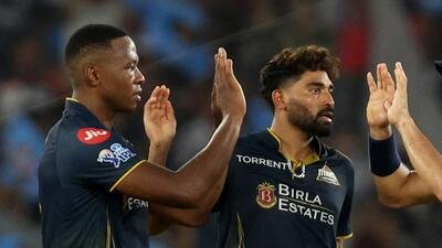 File picture of Gujarat Titans speedsters Kagiso Rabada and Mohammed Siraj after the South Africa fast bowler took a wicket against Punjab Kings. (REUTERS)