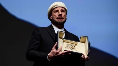 John Travolta received an honourary lifetime achievement Palm d'Or award prior to the screening of the film Propeller One-Way Night Coach at the 79th edition of the Cannes Film Festival. (Photo by Olivier CHASSIGNOLE / AFP) (AFP)