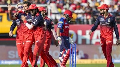 Royal Challengers Bengaluru's players celebrate during the match against Punjab Kings. (PTI)