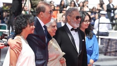 Indian filmmaker and producer Shivendra Singh Dungarpur (2L), Indian film editor Bina Paul (C) and Indian actor Joy Mathew (2R) pose as they arrive for the screening of the film "Amma Ariyan" (Report to your Mother) at the 79th edition of the Cannes Film Festival in Cannes, southern France on May 16, 2026. (Photo by Thibaud MORITZ / AFP) (AFP)