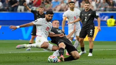 Iran's Shahriyar Moghanloo (20) battles for the ball with New Zealand's Finn Surman (16). (AP Photo) FIFA World Cup 2026 standings: How the groups shape up after 16 matches and historic day of draws