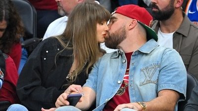 Singer Taylor Swift and Travis Kelce of the Kansas City Chiefs kiss during Game Three between the New York Knicks and the Cleveland Cavaliers in the NBA Eastern Conference Finals at Rocket Arena, May 23, 2026 in Cleveland, Ohio. (Getty Images via AFP)