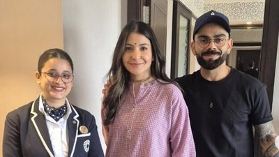 Virat Kohli and Anushka Sharma pose with a fan. Virat Kohli and Anushka Sharma pose with a fan.