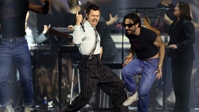 Viral videos sparked fears that extreme temperatures caused Harry Styles' fall at Wembley Stadium. However, reports say the singer briefly choked on water while performing his signature "whale" move (Photo by Adrian Dennis / AFP) (AFP)