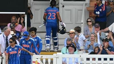 India's captain Harmanpreet Kaur walks back to the pavilion having lost her wicket for 56 during the ICC Women's T20 cricket world cup 2026 game between Australia and India, at Lord's in London on June 28, 2026. (Photo by JUSTIN TALLIS / AFP) (AFP)