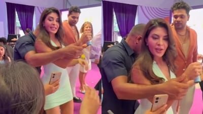 Jacqueline Fernandez bodyguard holds her wrist, stops her from clicking pictures with fans. Jacqueline Fernandez bodyguard holds her wrist, stops her from clicking pictures with fans.