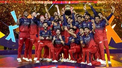 Royal Challengers Bengaluru's players celebrate with the trophy after winning IPL 2026. (PTI)
