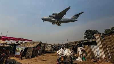 A US cargo plane, carrying vehicles and other supplies, flies over the slums near Sardar Vallabhbhai Patel International Airport, in Ahmedabad. (PTI Photo) India's world-class airports and the first-impression challenge facing its cities