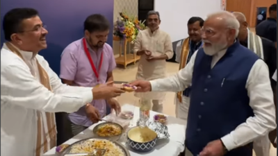 PM Modi eats Jhalmuri Watch: PM Modi enjoys jhalmuri at NDA meeting served by Bengal CM Suvendu Adhikari