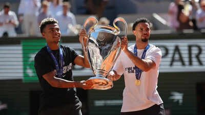 PSG's Desire Doue, left, and Warren Zaire-Emery walk onto the center court with Chgampions league trophy at the French Open tennis tournament in Paris, Monday, June 1, 2026. (AP Photo) Dembele brings Champions League trophy to French Open after PSG's title triumph - Watch