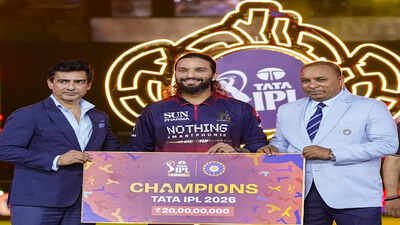BCCI President Mithun Manhas, left, and Secretary Devajit Saikia, right, hand over the tournament trophy to Rajat Patidar (PTI Photo) ‘I never dreamed of captaining RCB and lifting the trophy’: Rajat Patidar's emotional confession
