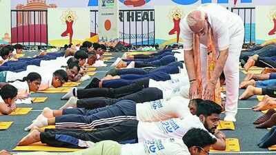 Right way to do it: PM Modi steps off yoga dais to guide participants
