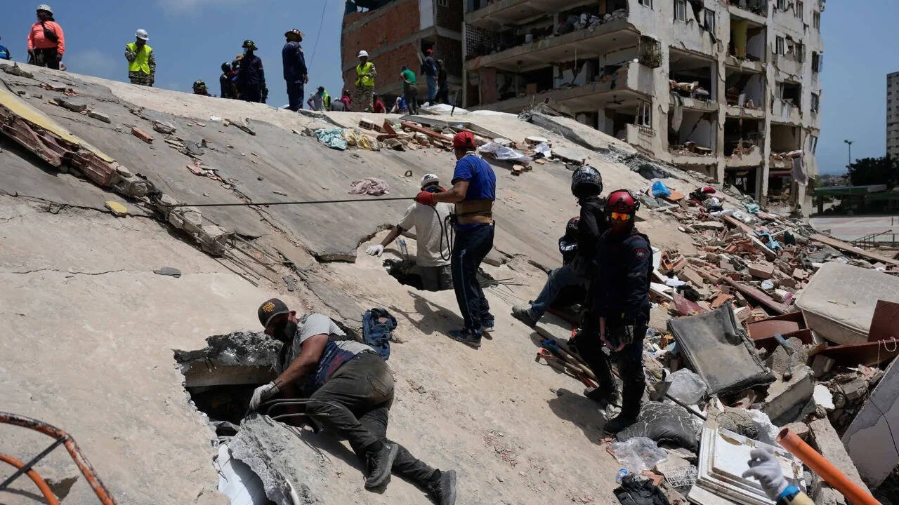 Rescue workers race to find survivors beneath the rubble. Photo credit: AP