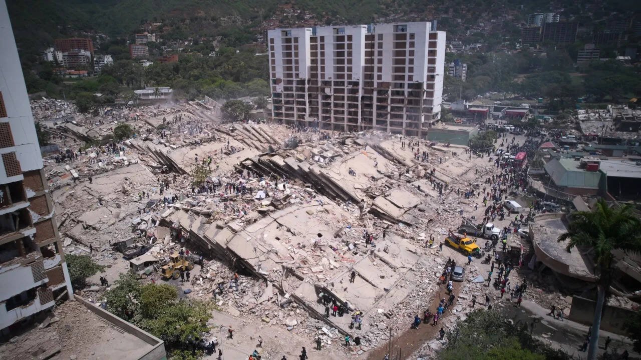 Residents and rescue workers sift through rubble two days after an earthquake hit La Guaira. Photo credit: AP