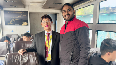 Tourist poses for a photograph with Sarita Yolmo. (Credit: ANI) Meet 55-year-old Sarita Yolmo, the first woman TTE on Darjeeling's iconic toy train whom tourists ask, “Are you a celebrity?”