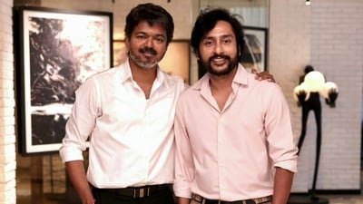 RJ Karuppu with Tamil Nadu CM Vijay. RJ Karuppu with Tamil Nadu CM Vijay.