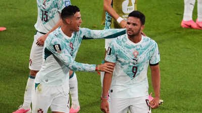 Portugal's Goncalo Ramos (9) is congratulated by Cristiano Ronaldo after scoring a a goal during the World Cup round of 32 soccer match between Portugal and Croatia (AP Photo) Portugal vs Croatia FIFA World Cup match result: Ramos, Ronaldo score as Portugal complete dramatic 2-1 comeback win over Croatia to enter R16