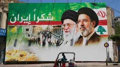 A giant billboard showing late Iranian leader Ayatollah Khamenei and Iranian Supreme Leader Mojtaba Khamenei, with Arabic writing that reads: "Thank you Iran" (Image/AP) The son who never appears: Iran buries a Supreme Leader — and inherits a ghost