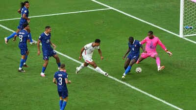 England's Jude Bellingham (10) shoots the ball past France goalkeeper Mike Maignan (16) to score their sixth goal during the World Cup third-place playoff match between France and England. (AP Photo) France vs England FIFA World Cup third-place match result: Kylian Mbappe breaks all-time WC goal record as Bukayo Saka hat-trick fails France in 10-goal thriller