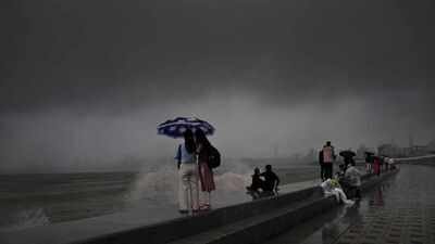 Visitors watch waves crash against the Marine Drive promenade under dark monsoon skies Photograph by SL Shanth Kumar/TNN 'Rain is only good for those sipping coffee from their balconies': Every monsoon, same old story in Mumbai