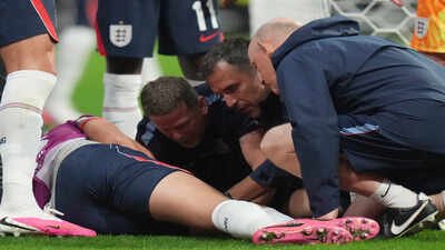 England's Jordan Henderson is looked after by staff following an injury in the postgame celebration. (AP Photo) FIFA World Cup: Blow for England before Norway clash as Jordan Henderson ruled out after freak celebration injury