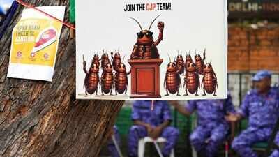 A poster of Cockroach Janata Party (CJP) during the seventh day of a hunger strike by CJP. (PTI Photo) One post, 6 words, 37 days, one resignation: How 'cockroaches' crawled into corridors of power