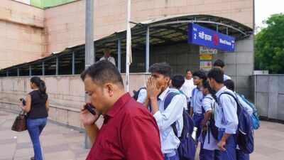 School students wait outside Mandi House Metro station (PTI Photo) Big relief for commuters, all 18 Delhi Metro stations now reopen as CJP withdraws protest