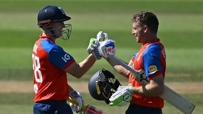 England's Jos Buttler (R) celebrated his 51-ball 100 with England's Harry Brook (L) during the fifth T20I. (AFP)