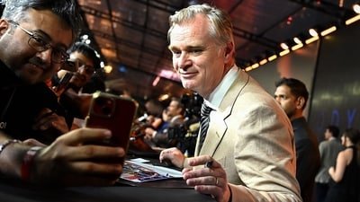 British-American filmmaker Christopher Nolan (R) poses with a fan upon his arrival to attend the red carpet for the premiere of the film 'The Odyssey' in Mumbai on July 11, 2026. (AFP) British-American filmmaker Christopher Nolan (R) poses with a fan upon his arrival to attend the red carpet for the premiere of the film 'The Odyssey' in Mumbai on July 11, 2026. (AFP)