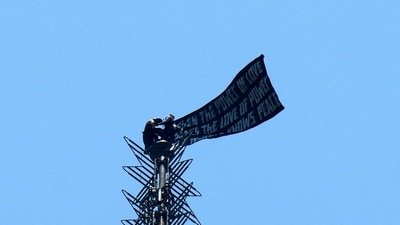 Two people display a banner atop the Empire State Building in the Manhattan borough of New York, U.S., July 1, (REUTERS)