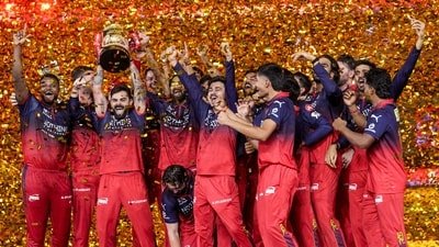 Royal Challengers Bengaluru's players celebrate with the tournament trophy during the presentation ceremony after winning the Indian Premier League (IPL) 2026 title, in Ahmedabad. (PTI)