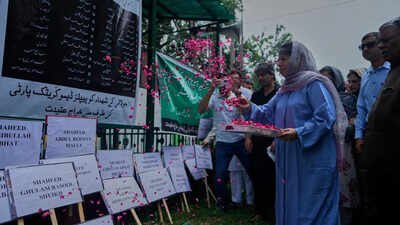 Mehbooba Mufti offers rose petals in tribute to martyrs at her party office (Picture credit: AP) Jammu & Kashmir administrtion seals Martyrs’ Graveyard; Omar, Mehbooba pay homage at party offices
