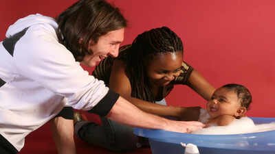 20-year-old soccer star Lionel Messi helps to bathe Lamine Yamal, who was merely six months old at the time with Yamal's mother Sheila Ebana during a photo session in Sept. 2007 in the dressing room of the Camp Nou stadium in Barcelona, Spain. (AP Photo/Joan Monfort) OFFSIDE | The Baptism of Yamal by 'Saint' Messi: The 19-year-old photograph that became World Cup final's origin story