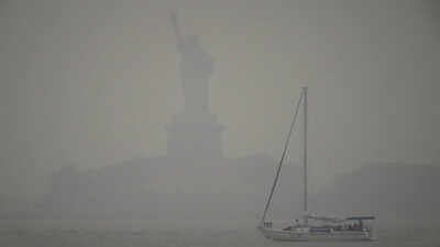 The Statue of Liberty stands during sunset as smoke from wildfires blankets the sky on Thursday. (AP Photo) FIFA World Cup final in danger? Wildfire haze engulfs New Jersey as Spain train through toxic smoke