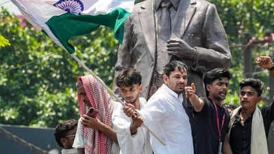 RJD leader Tej Pratap Yadav stands atop the statue of former Mauritius Prime Minister Seewoosagur Ramgoolam (PTI photo) Lalu Yadav's son Tej Pratap Yadav arrested in Patna NEET protest case, sent to 14-day judicial custody