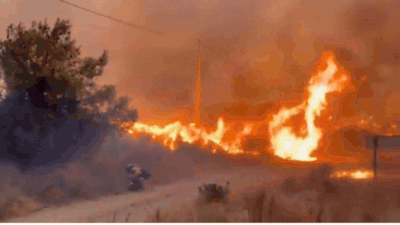 Visuals released by Andalusia's emergency services show firefighters battling towering flames amid powerful winds, while other footage captures crews attempting to bring the blaze under control as thick smoke engulfs surrounding hillsides. Watch: Massive wildfire turns sky orange in southern Spain as death toll rises to 12