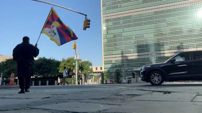 Activist Lobga Rangzen walks carrying a Tibetan flag near the UN headquarters, before setting himself on fire (Picture credit: Reuters) Self-immolation outside UN draws fresh attention to Tibet