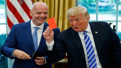 FILE - President Donald Trump holds up a red card during a meeting with FIFA president Gianni Infantino in the Oval Office of the White House, Tuesday, Aug. 28, 2018, in Washington. (AP Photo/Evan Vucci, File) Balorin's Red-Card Reversal: Why FIFA just can't say no to Donald Trump