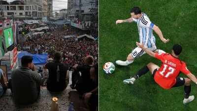 Palestinians watch a live broadcast of the World Cup round of 16 match between Argentina and Egypt in Nuseirat, central Gaza Strip (left), and Lionel Messi battles for the ball with Egypt's Mohanad Lashin (AP Photo) Israeli strike kills Gaza's Argentina-Egypt FIFA World Cup screenings organiser before kickoff