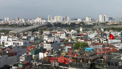 A view of Hanoi showing the Red River, with a bridge spanning the river and densely populated neighborhoods lining its banks How Vietnam capital Hanoi's $2.4-billion redevelopment drive is reshaping city's real estate landscape
