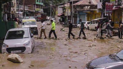 Doda: People walk through debris after a flash flood triggered by a cloudburst, at Thathri, in Jammu and Kashmir's Doda district. (PTI Photo)(PTI07_07_2026_000524B) Heavy rains trigger flash floods in Doda, damage houses and roads