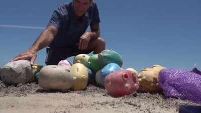 Why dozens of mystery piggy banks suddenly appeared on Texas shoreline: How much cash did they contain?